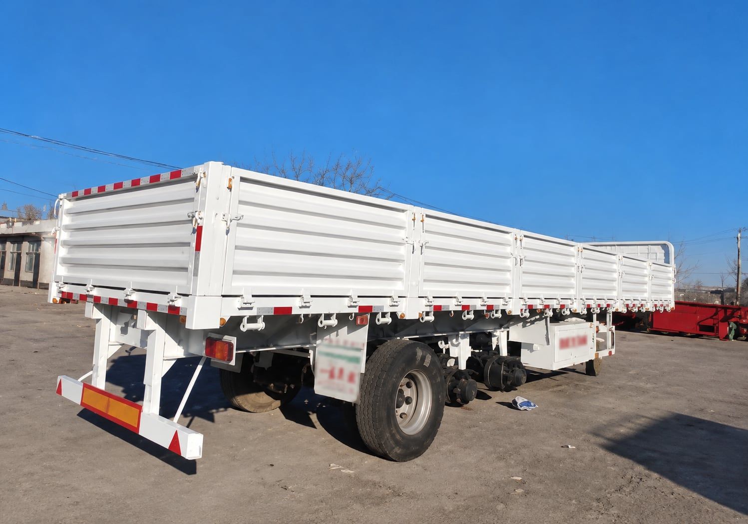 CYP9400L 800 mm Drop-Side Semi-Trailer photographed from the front three-quarter with the drop sides up and the landing legs down