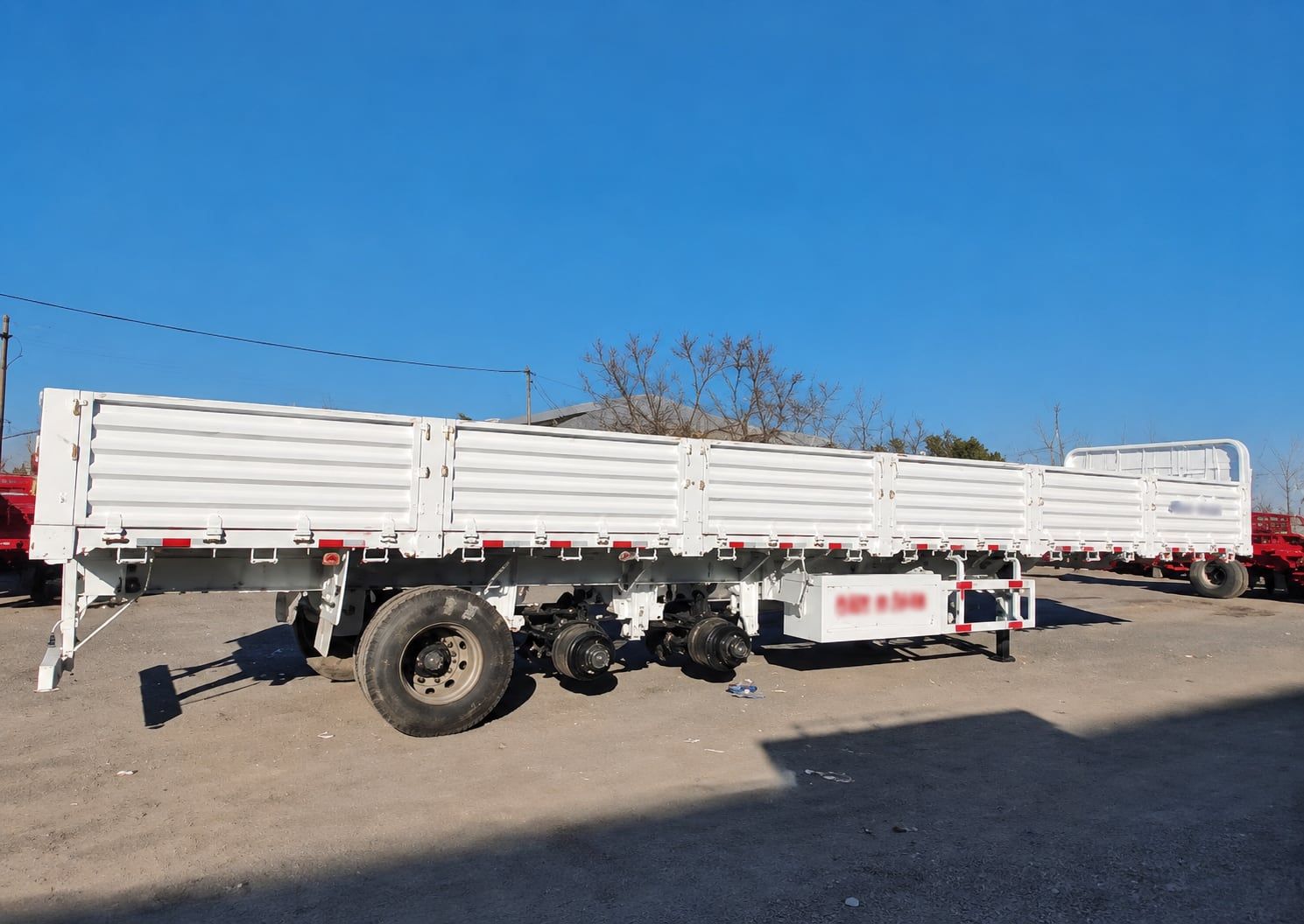 CYP9400L 800 mm Drop-Side Semi-Trailer seen from the side, drop sides up, showing the full length and the three axles