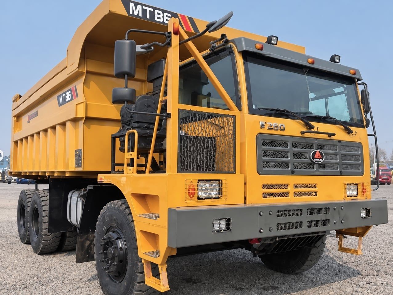 SDLG Wide-Body Mining Truck photographed three-quarter front in the yard, yellow cab and yellow dump body