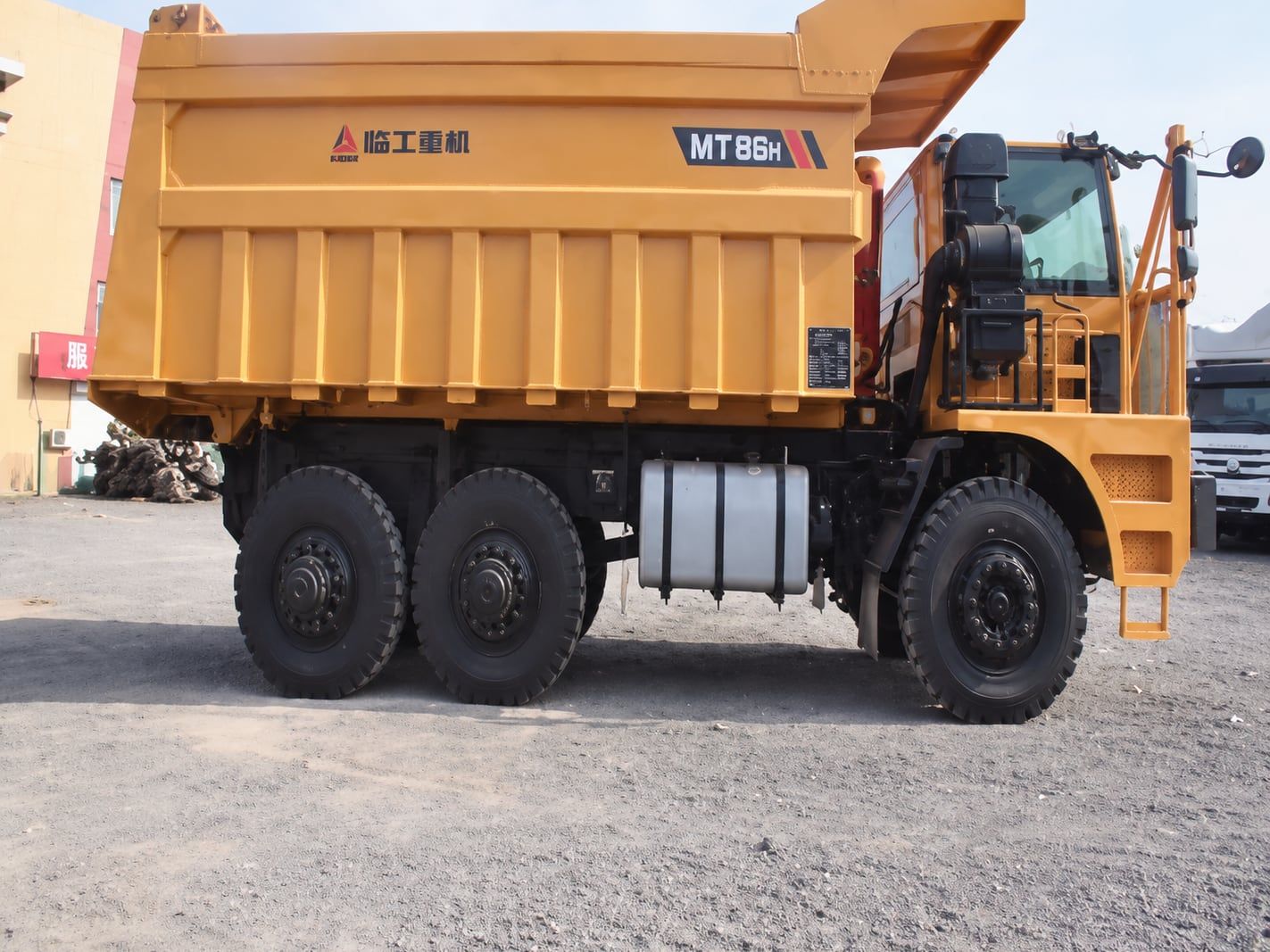 SDLG Wide-Body Mining Truck seen from the side, showing the full length of the dump body and the rear axles