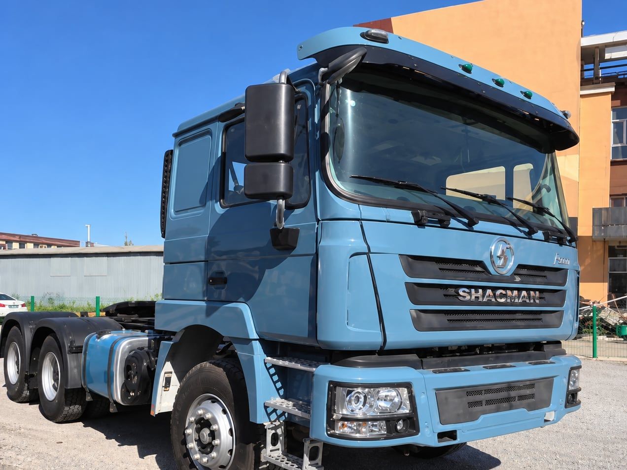 Shacman Delong F3000 6×4 Tractor Truck photographed front three-quarter in the yard, light blue cab