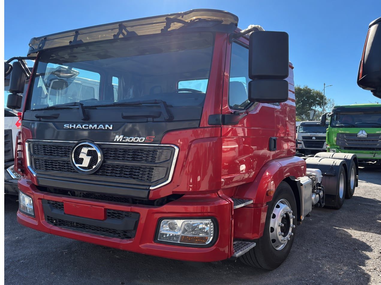 Shacman Delong M3000 6×4 Tractor Truck photographed three-quarter front, red Shacman cab