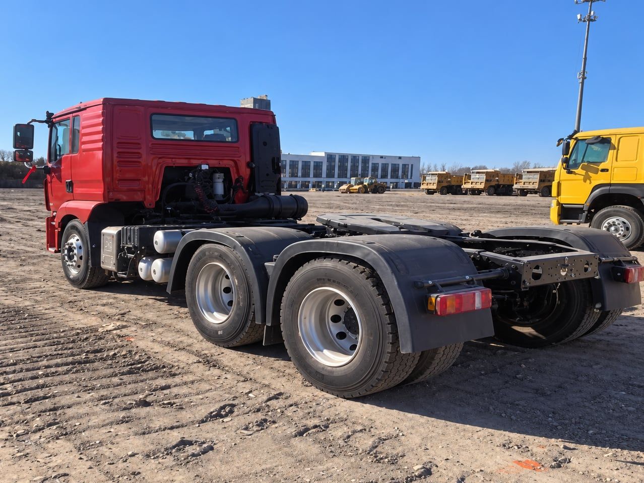 Shacman Delong M3000 6×4 Tractor Truck seen from the rear three-quarter, showing the chassis, the fifth wheel and the twin rear axles