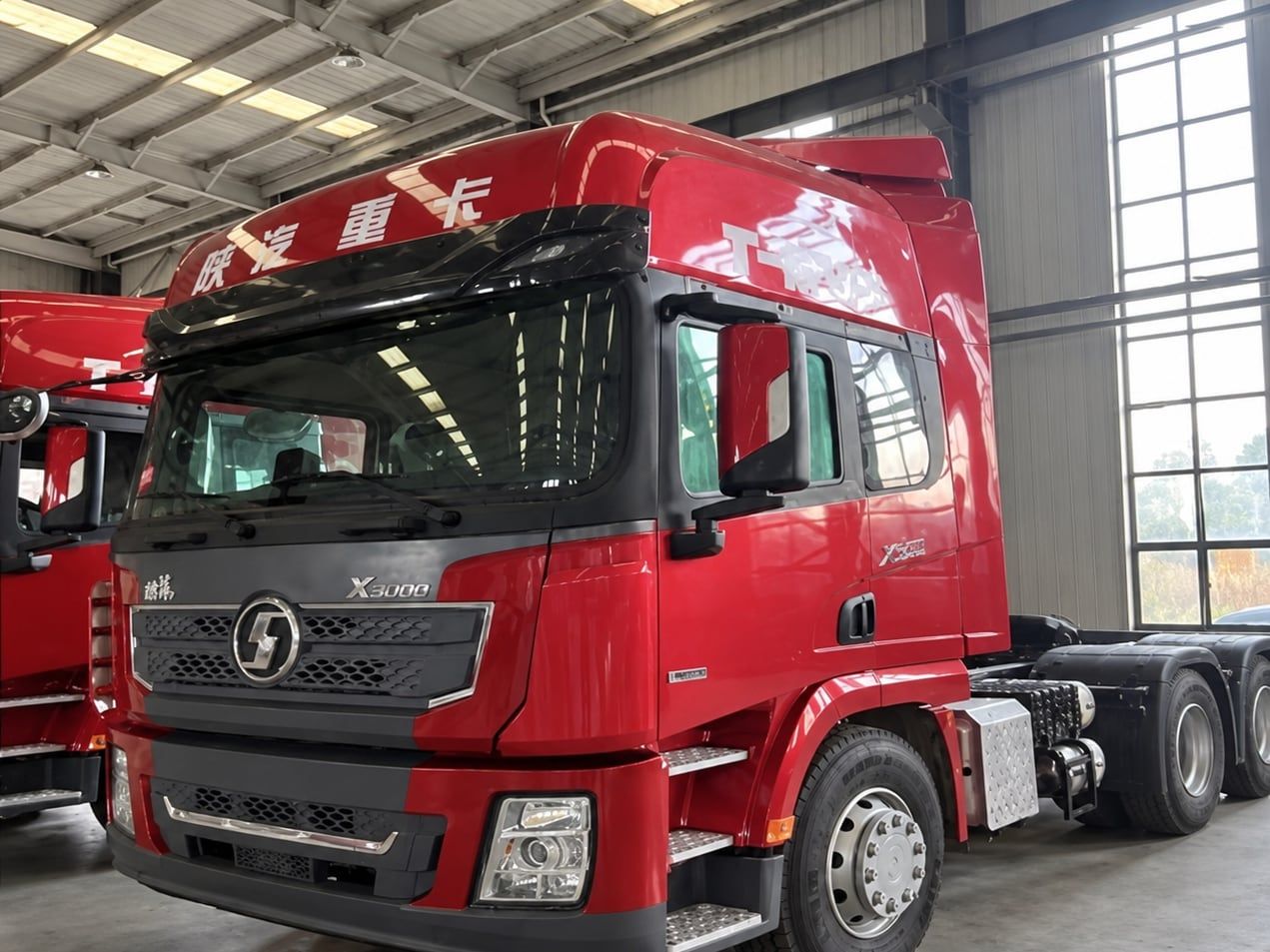 Shacman Delong X3000 6×4 Tractor Truck photographed three-quarter front indoors, red Shacman cab