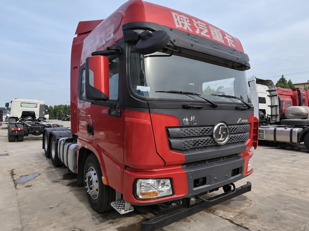 Shacman Delong X3000 6×4 Tractor Truck photographed front three-quarter, red cab, fifth wheel empty