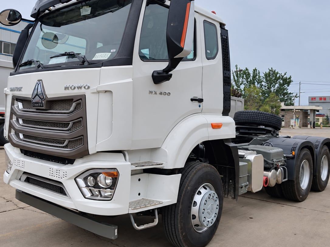 Sinotruk HOWO 6×4 Tractor Truck photographed three-quarter front in the yard, white cab, fifth wheel empty