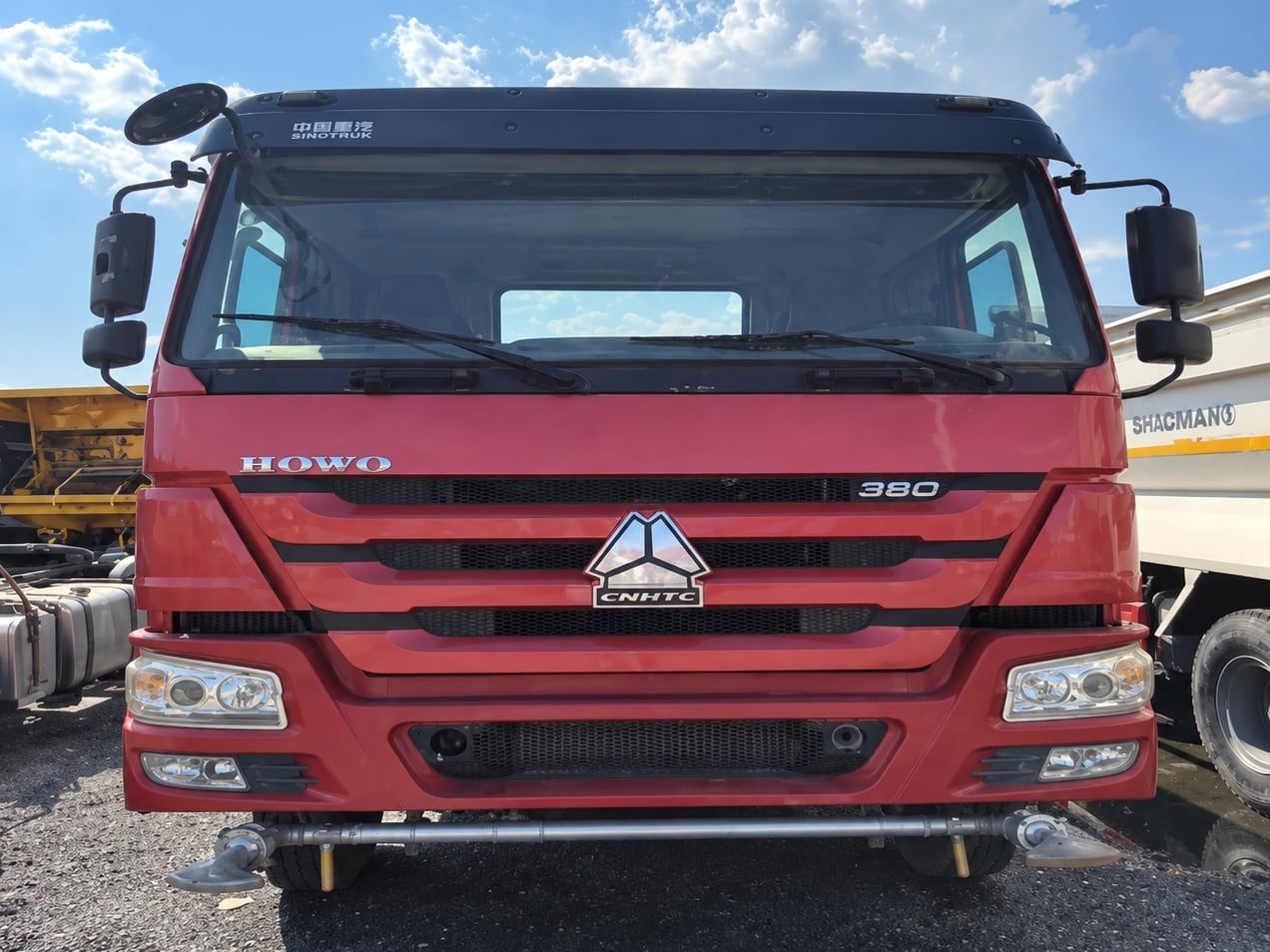 Sinotruk HOWO 6×4 Water Truck seen head-on, showing the full width of the red cab and the 380 badge