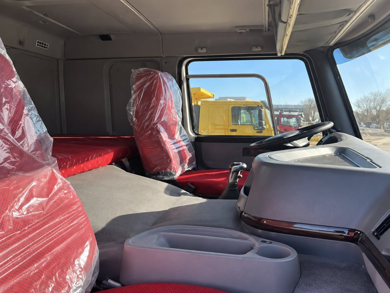 Sinotruk HOWO 8×4 Dump Truck inside the cab, seats still wrapped in delivery plastic