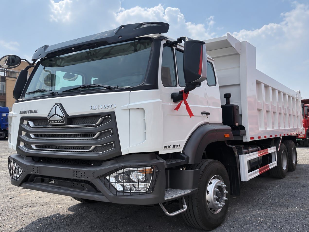 Sinotruk HOWO NX 6×4 Dump Truck photographed three-quarter front, white cab and white tipper body
