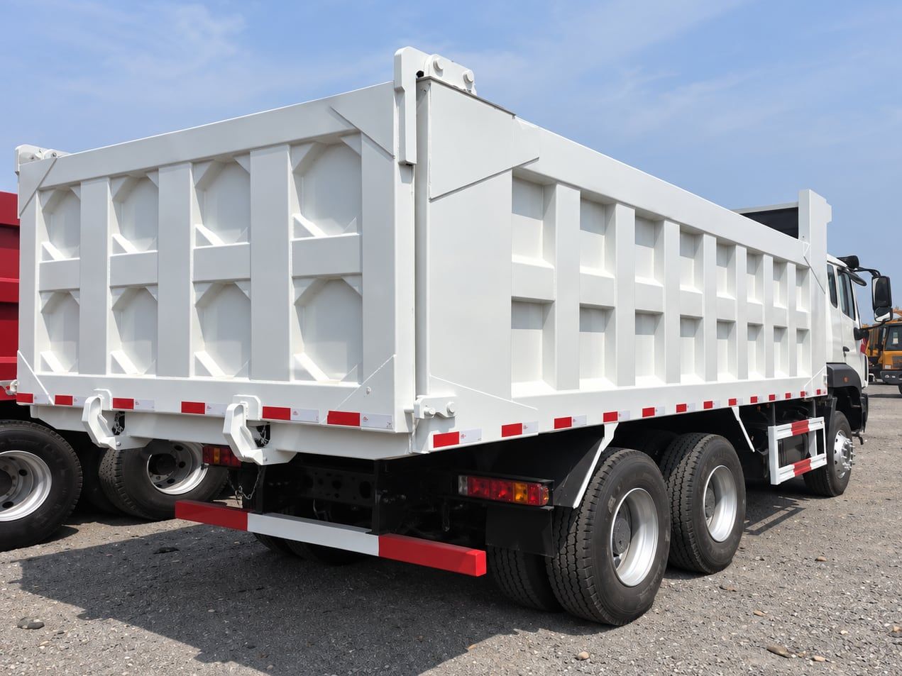 Sinotruk HOWO NX 6×4 Dump Truck the white tipper body seen from the rear three-quarter, showing the twin rear axles