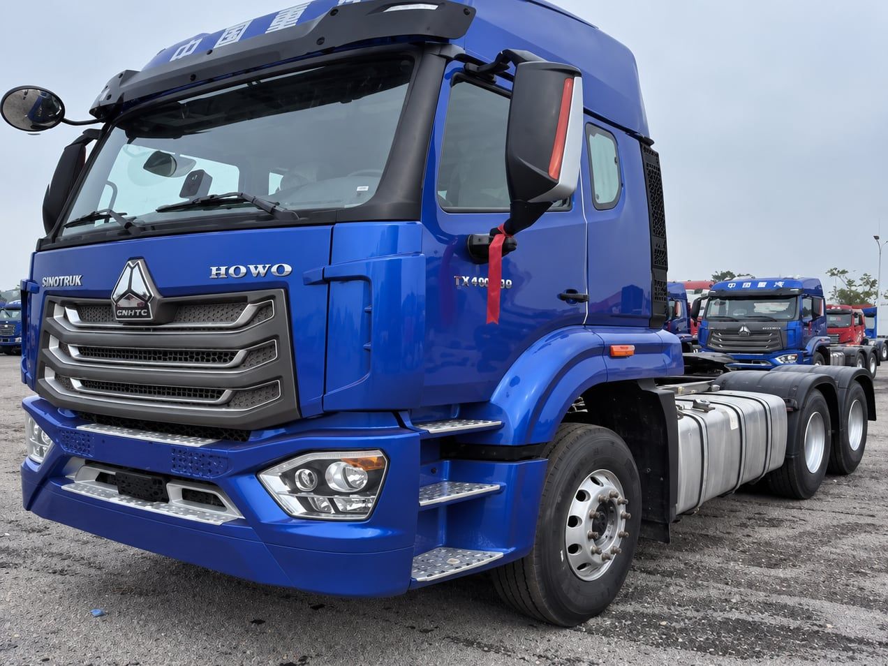 Sinotruk HOWO NX 6×4 Tractor Truck photographed three-quarter front, blue cab, fifth wheel empty