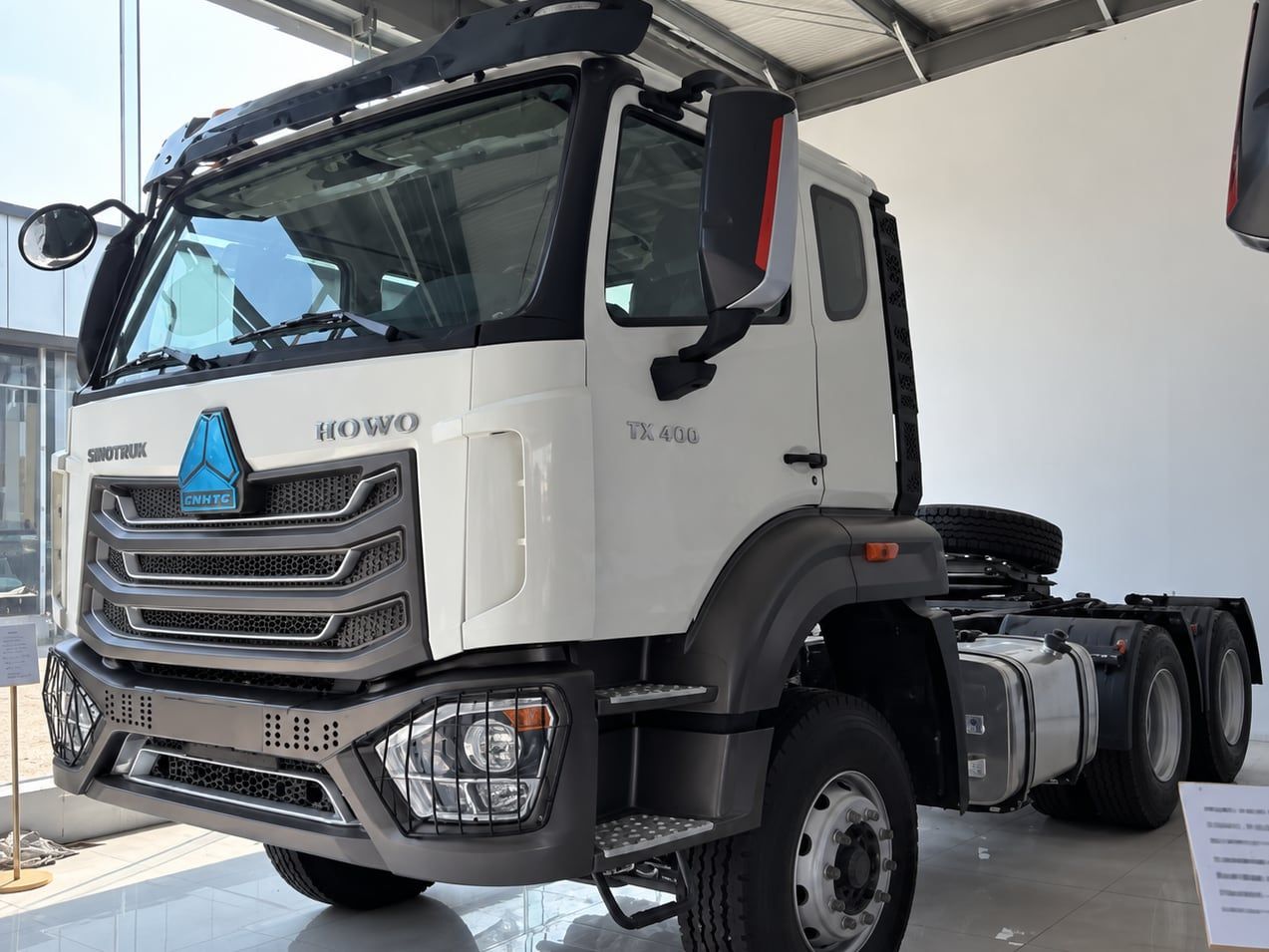 Sinotruk HOWO NX 6×4 Tractor Truck photographed three-quarter front, white cab, fifth wheel empty