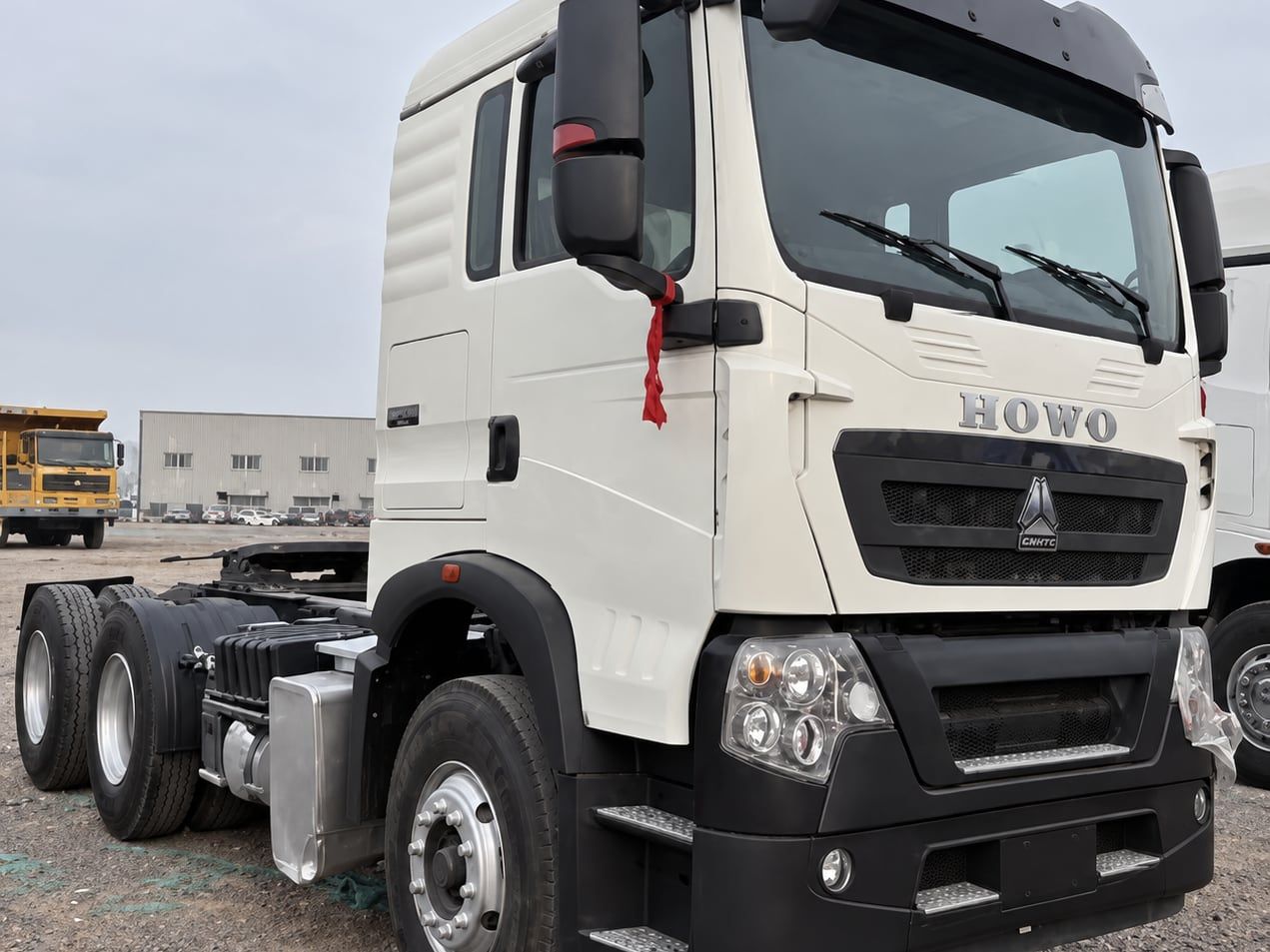 Sinotruk HOWO TX 6×4 Tractor Truck photographed three-quarter front in the yard, white cab
