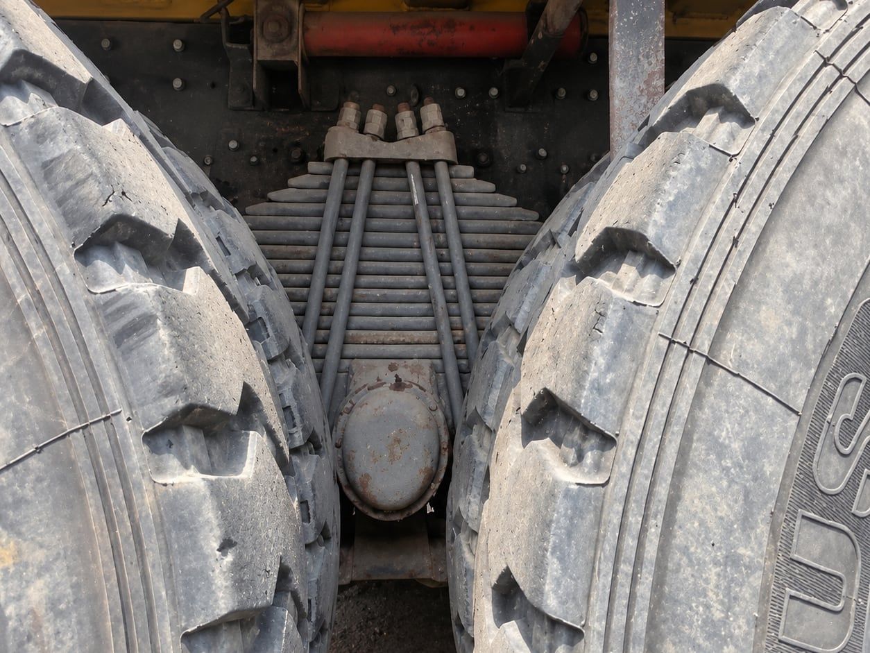 Tonly Wide-Body Mining Truck the twin rear tyres and the drive axle, photographed from below and behind